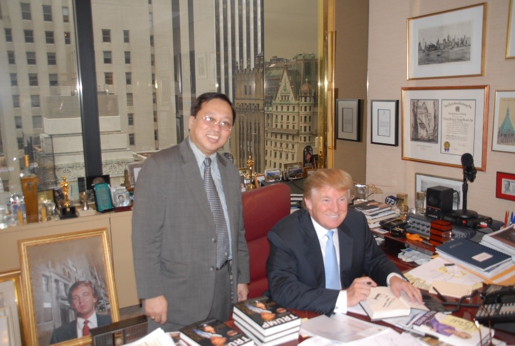 Author Donald Trump signing and giving book to Prof. Ha Ton Vinh